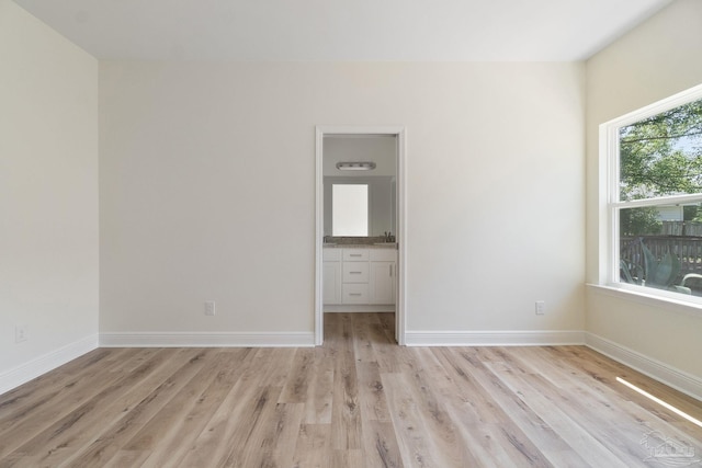 unfurnished bedroom with light wood-style floors and baseboards