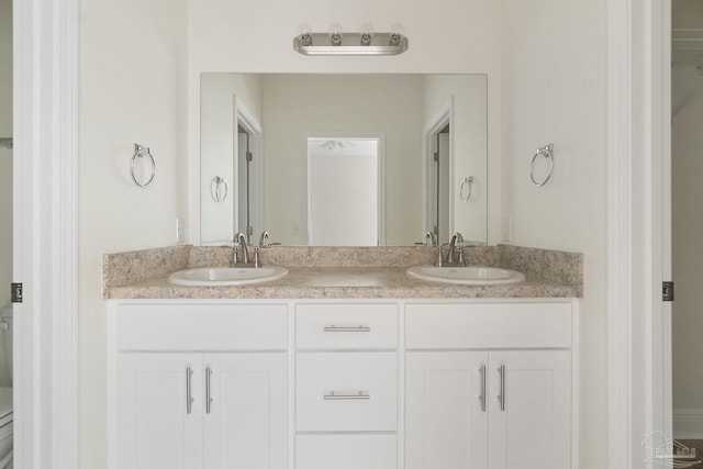 full bathroom featuring double vanity and a sink