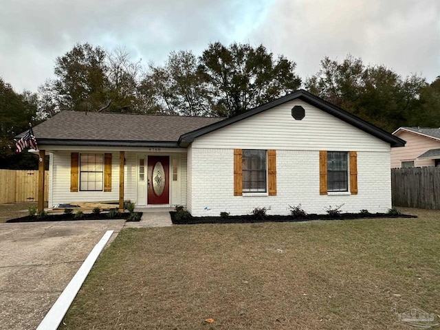 single story home featuring covered porch and a front lawn