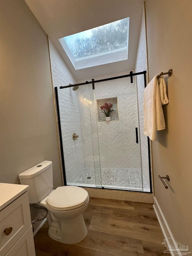 bathroom with vanity, a skylight, wood-type flooring, and walk in shower