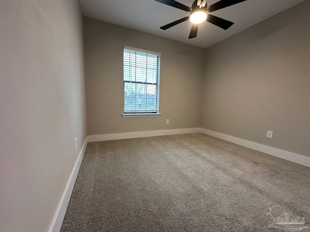 carpeted spare room featuring ceiling fan