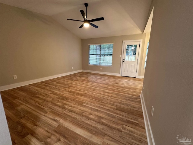 unfurnished room featuring wood-type flooring, vaulted ceiling, and ceiling fan