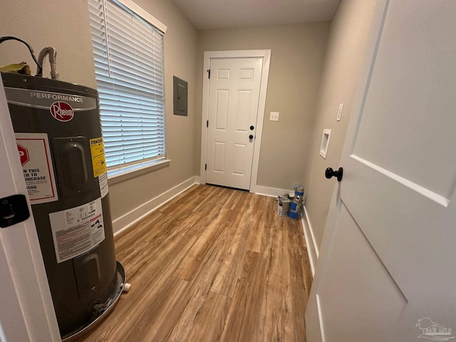 interior space featuring light hardwood / wood-style flooring, electric panel, and water heater