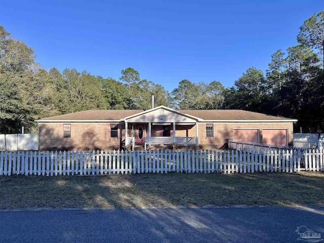 view of front of home featuring covered porch and a fenced front yard