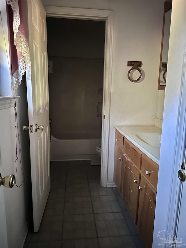 bathroom featuring tub / shower combination, vanity, and toilet