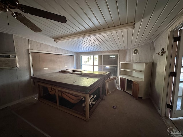 rec room featuring ceiling fan, wooden walls, cooling unit, and beamed ceiling