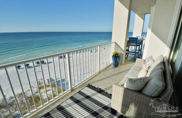 balcony with view of water and beach