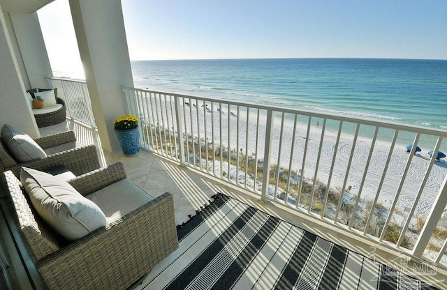 balcony with view of water and beach
