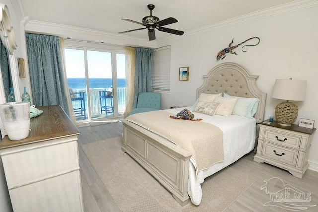 bedroom with access to exterior, crown molding, light wood-style flooring, a water view, and ceiling fan