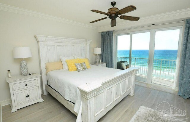 bedroom featuring access to outside, light wood-style flooring, crown molding, a water view, and a ceiling fan