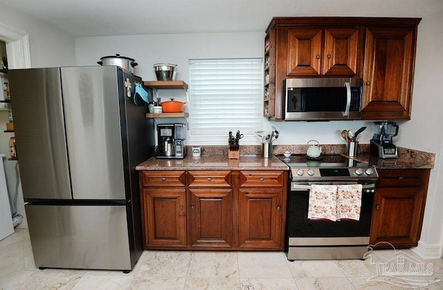 kitchen with stainless steel appliances, dark stone countertops, and open shelves