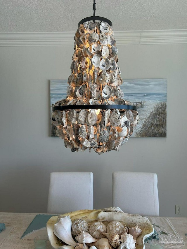 dining area view of ornamental molding and a textured ceiling