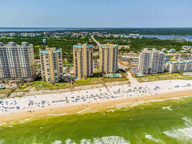 birds eye view of property featuring a water view and a beach view