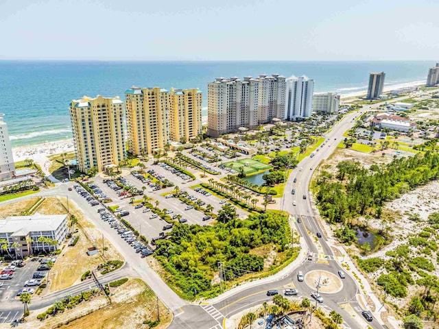 birds eye view of property with a beach view and a water view