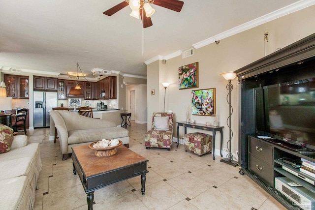 living room featuring ceiling fan, light tile patterned floors, and ornamental molding