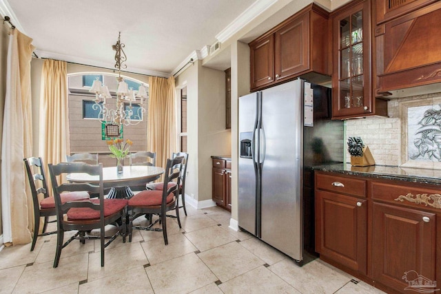 kitchen featuring hanging light fixtures, decorative backsplash, crown molding, stainless steel fridge with ice dispenser, and a notable chandelier