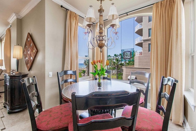 dining room featuring ornamental molding and a notable chandelier