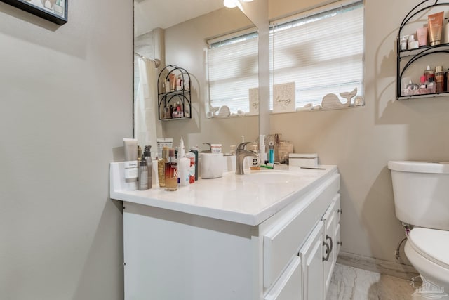 bathroom featuring toilet and vanity