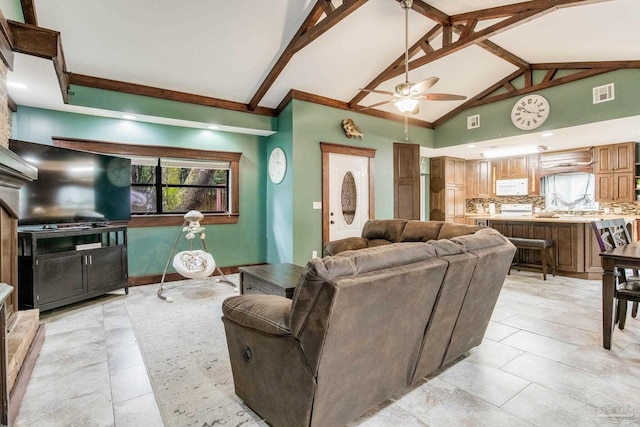 living room with ceiling fan, high vaulted ceiling, and beamed ceiling