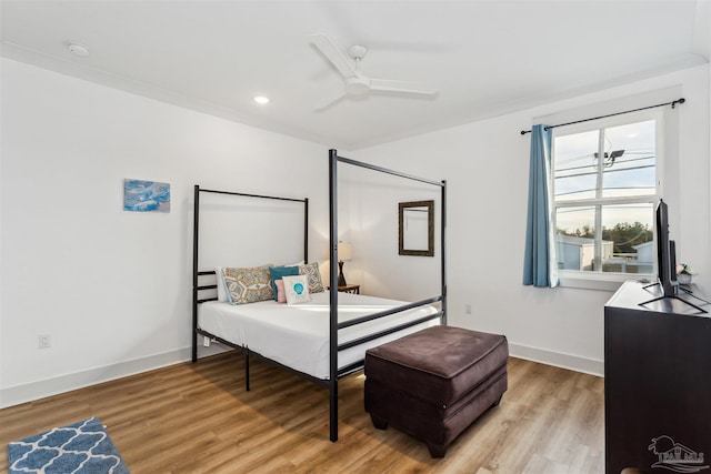 bedroom with wood-type flooring and ceiling fan with notable chandelier