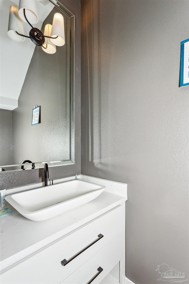 bathroom with vanity and vaulted ceiling