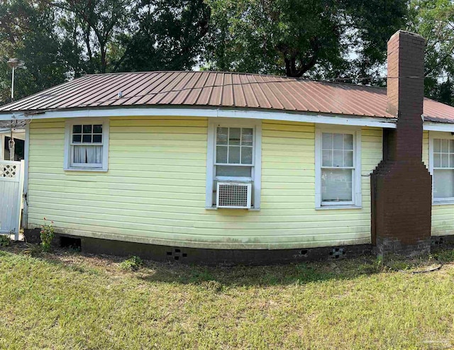 view of home's exterior featuring a lawn and cooling unit