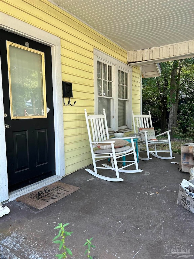 view of exterior entry with a porch