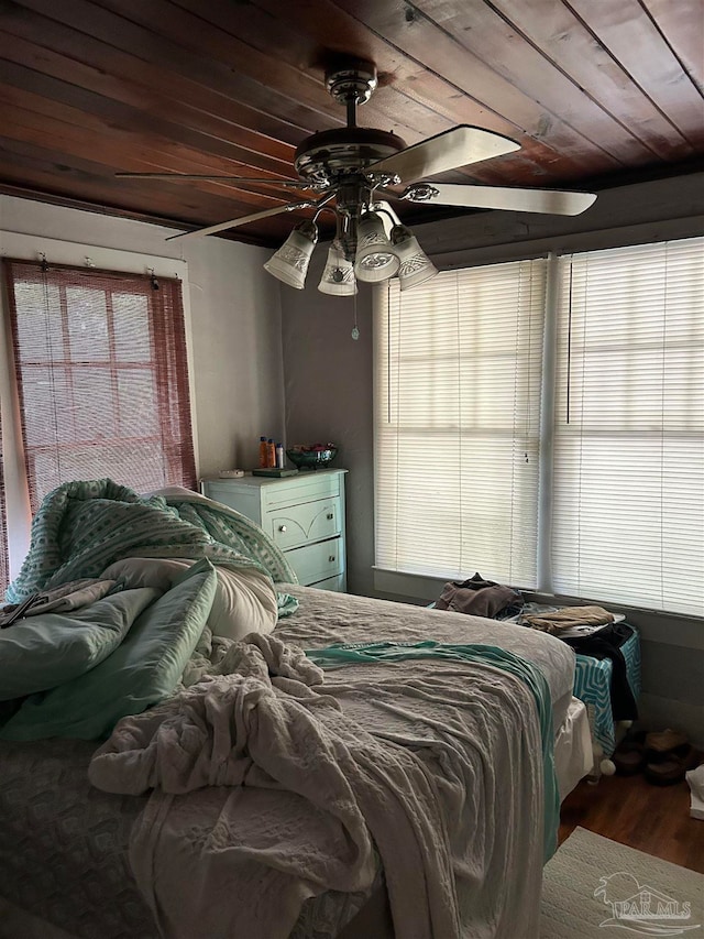 bedroom with ceiling fan, hardwood / wood-style flooring, and wooden ceiling