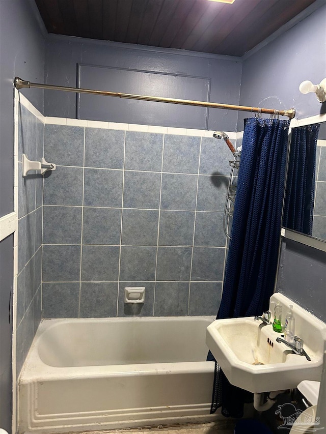 bathroom featuring shower / bath combination with curtain, wood ceiling, and sink