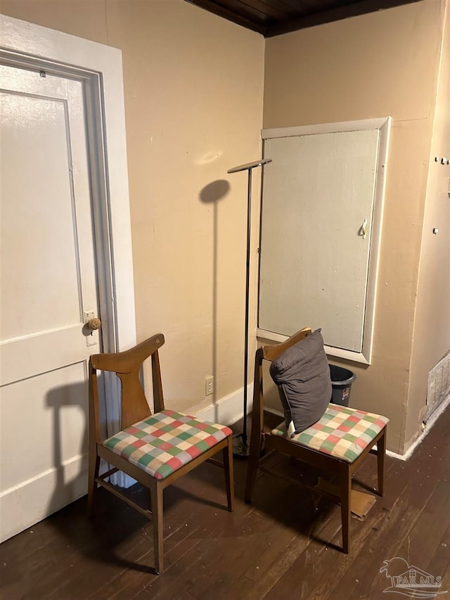 sitting room with dark wood-type flooring