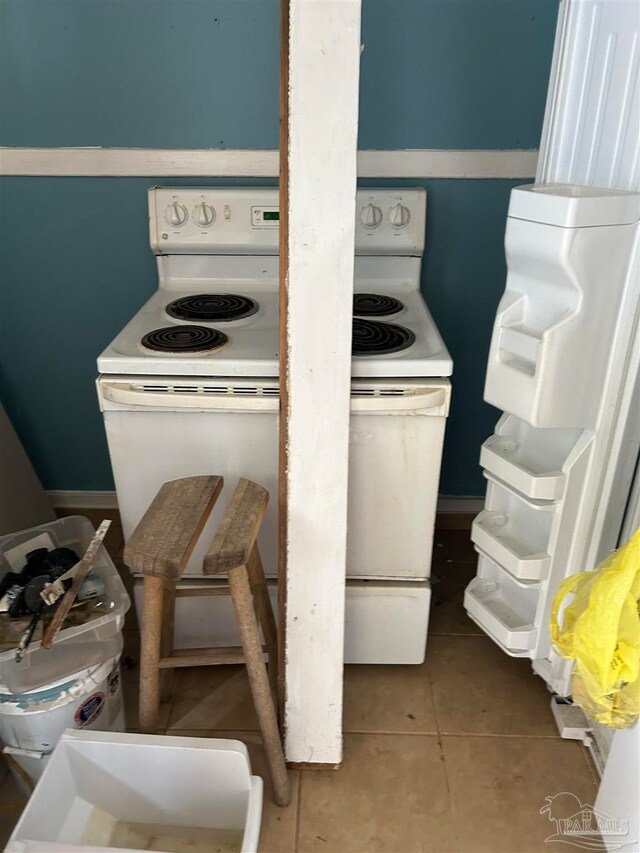 details with electric range and tile patterned floors