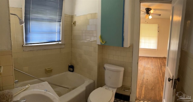 full bathroom with hardwood / wood-style flooring, sink, ceiling fan, tiled shower / bath, and toilet