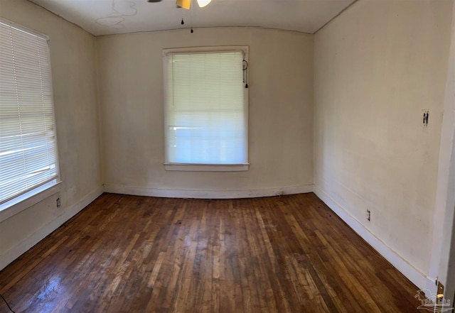 empty room with ceiling fan and dark wood-type flooring