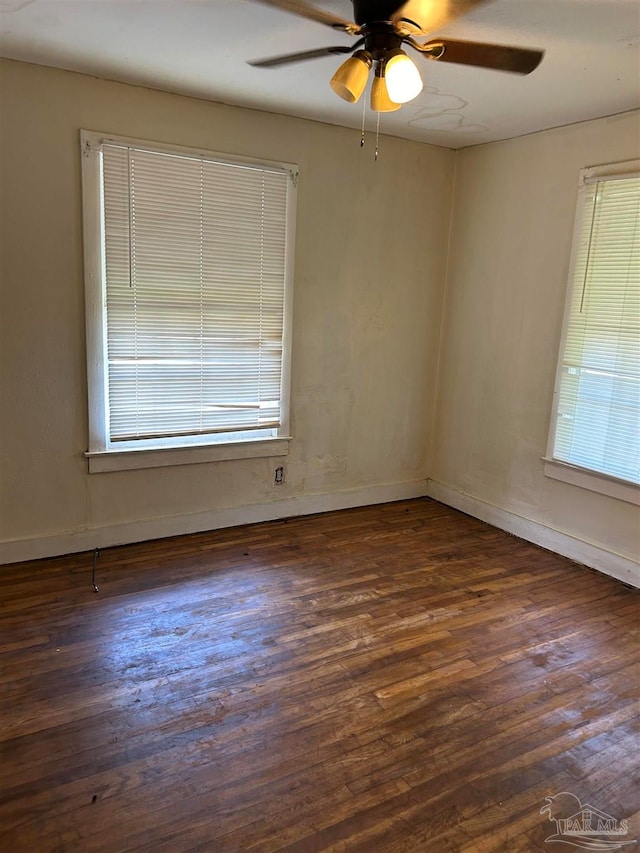 empty room featuring ceiling fan and dark hardwood / wood-style floors