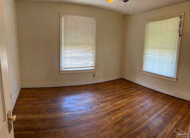 spare room with ceiling fan and dark hardwood / wood-style floors