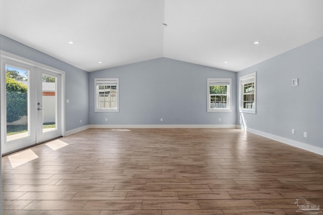 103 Florida Ave, Gulf Breeze, FL 32561 - unfurnished living room with lofted ceiling, baseboards, french doors, and wood finished floors