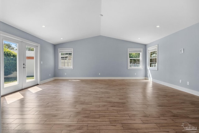 interior space with french doors, lofted ceiling, and light hardwood / wood-style flooring