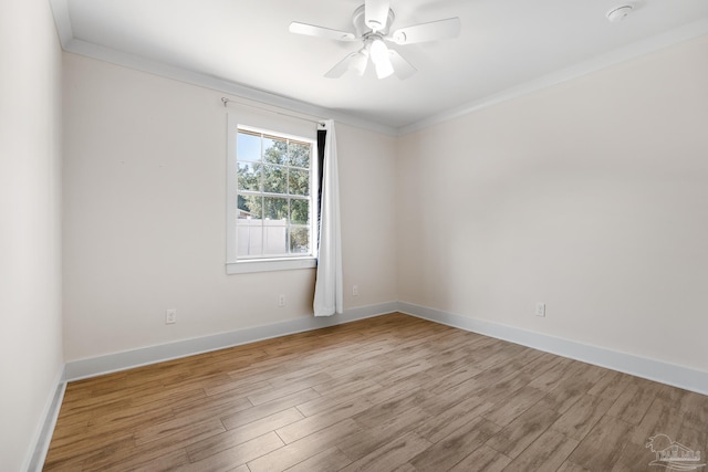 empty room with crown molding, ceiling fan, and light hardwood / wood-style flooring