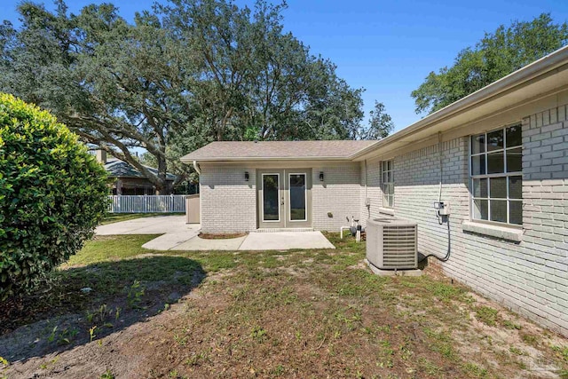 rear view of house featuring central air condition unit, french doors, and a patio area