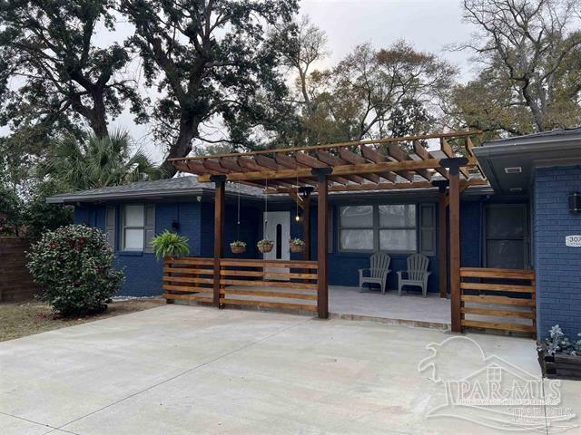 rear view of house with a pergola