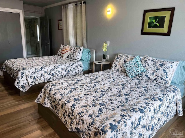 bedroom with wood-type flooring