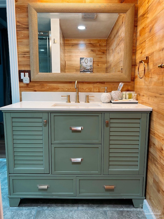 bathroom featuring wood walls and vanity