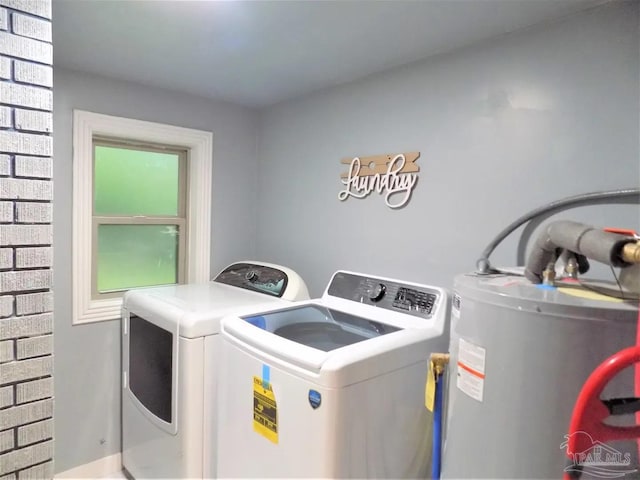 laundry area with washer and dryer and electric water heater