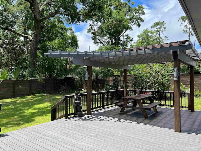 deck with a pergola and a yard