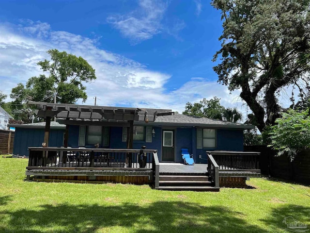 rear view of property featuring a pergola, a deck, and a yard