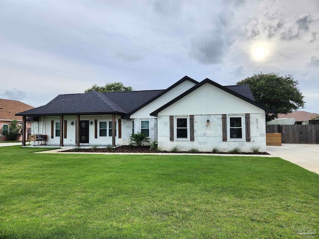 ranch-style home with a porch and a front lawn