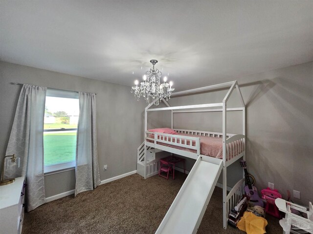 unfurnished bedroom featuring a chandelier and dark carpet