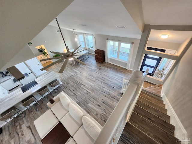 unfurnished living room with hardwood / wood-style floors and ceiling fan