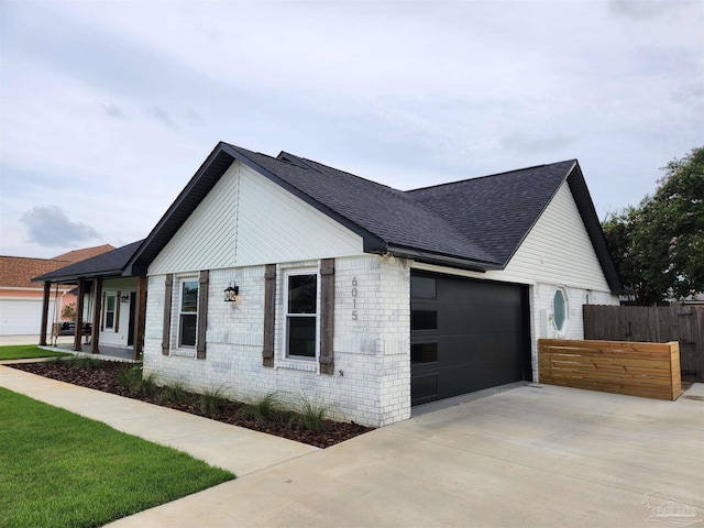 view of home's exterior with a porch and a garage