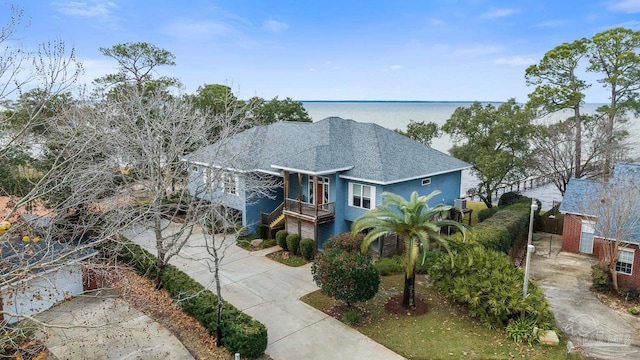 view of front of property with covered porch and a water view